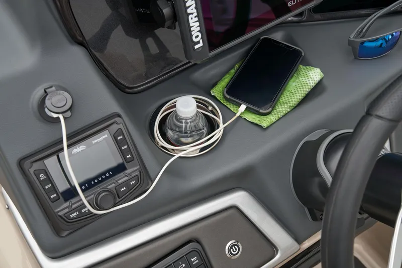 Slide: The Image of 2024 Ranger Reata 220F dashboard with phone charging and Lowrance electronics. - 35