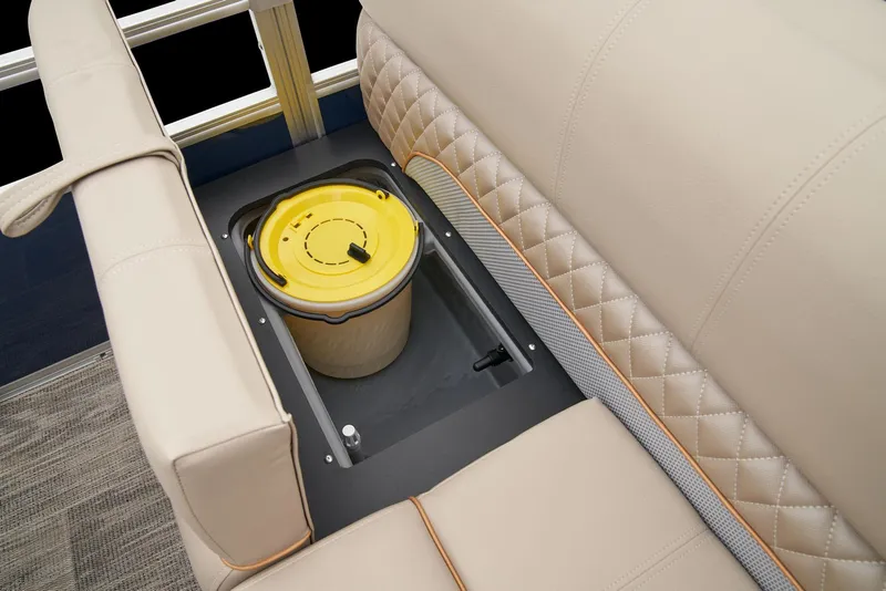 Slide: The Image of 2024 Ranger Reata 220F boat with built-in storage compartment and beige cushioned seating. - 47