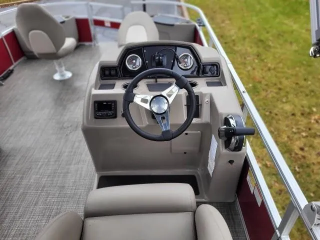 Slide: The Image of 2024 Ranger Reata 200F boat interior with steering wheel and seating. - 3