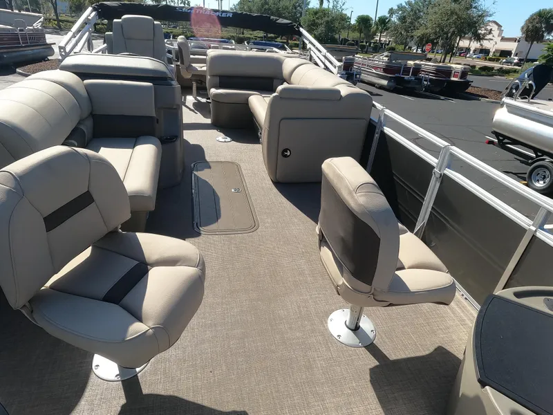 Slide: The Image of 2024 Sun Tracker Fishin' Barge 22 XP3 interior with spacious seating and fishing chairs. - 4