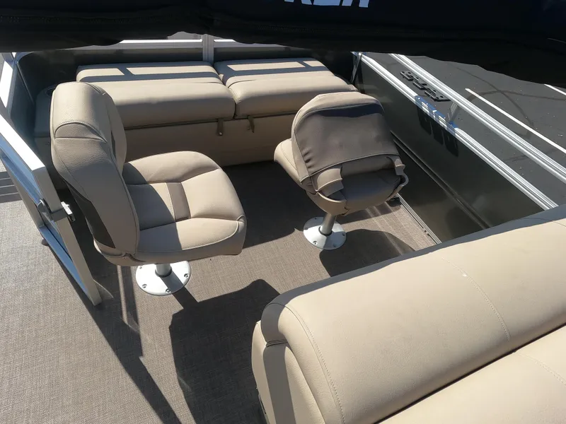 Slide: The Image of 2024 Sun Tracker Fishin' Barge 22 XP3 interior seating area with beige upholstery. - 9