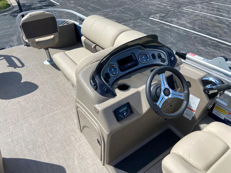 Slide: The Image of 2023 Sun Tracker Fishin' Barge 22 DLX boat interior with steering console and seating. - 5
