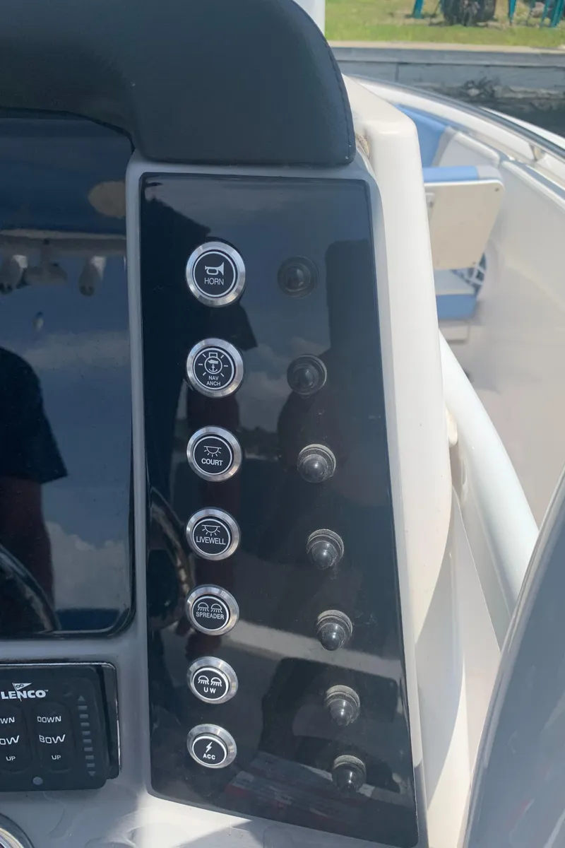 Slide: The Image of Control panel of 2022 Robalo R230 boat with various function buttons. - 12