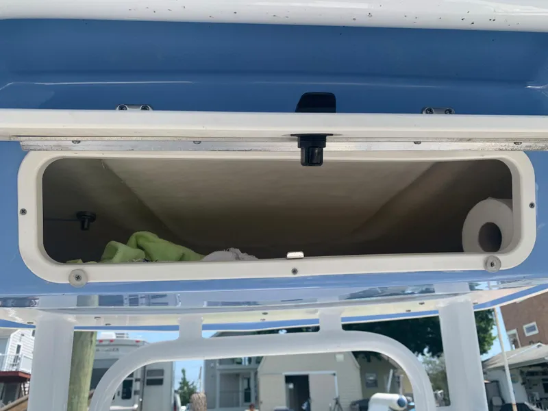 Slide: The Image of Storage compartment of a 2022 Robalo R230 boat with open hatch. - 13