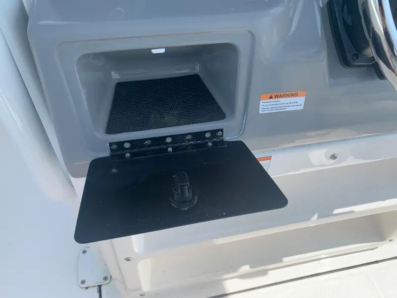 Slide: The Image of 2022 Robalo R230 boat storage compartment with open hatch. - 14