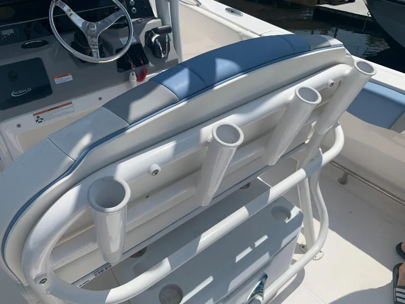 Slide: The Image of 2022 Robalo R230 boat interior with rod holders and steering wheel. - 17