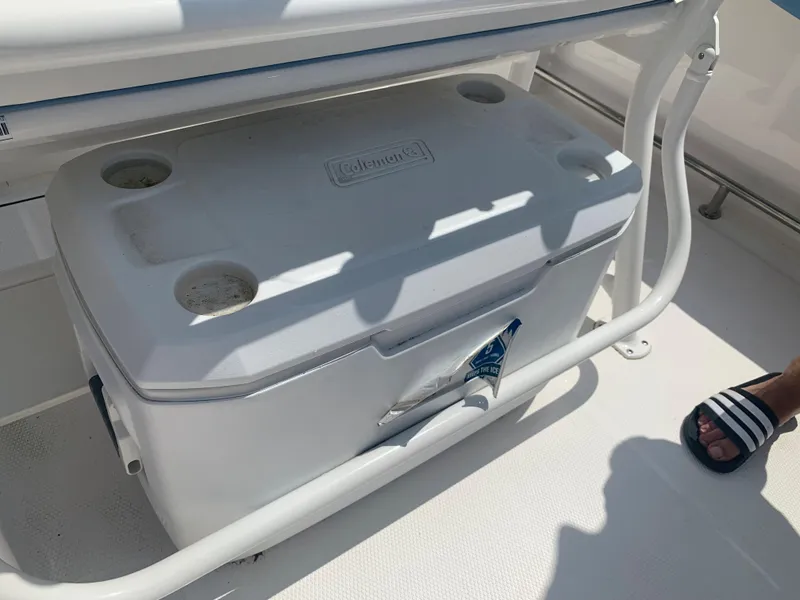 Slide: The Image of White Coleman cooler on a 2022 Robalo R230 boat deck. - 18