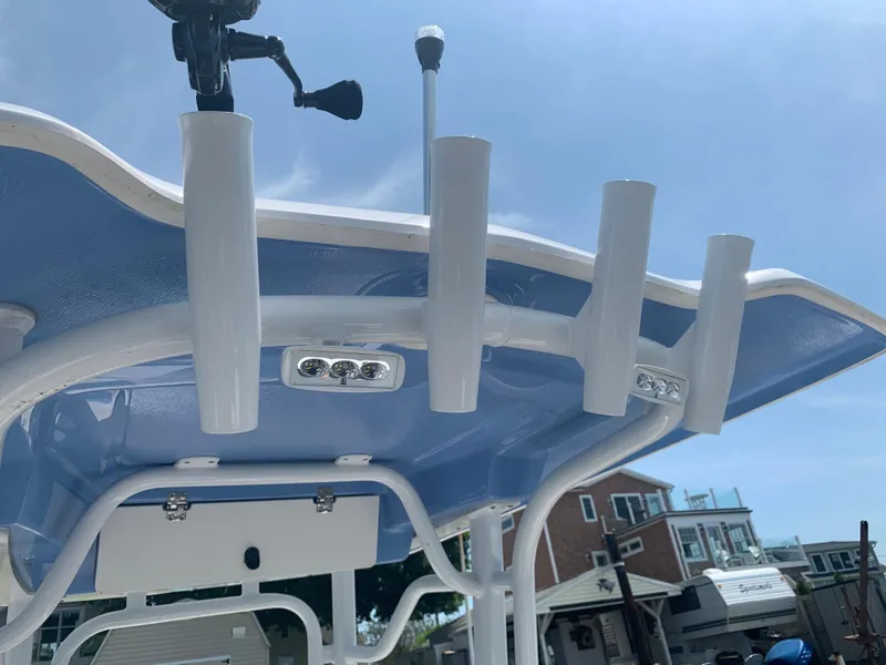 Slide: The Image of 2022 Robalo R230 boat with rod holders and LED lights on the T-top. - 19