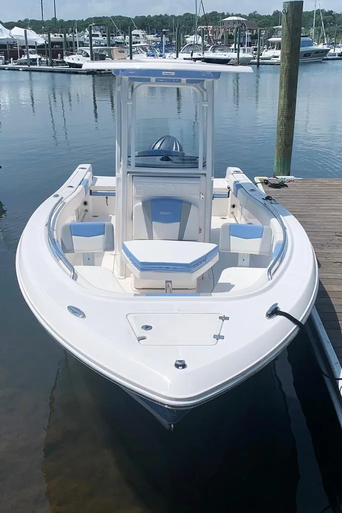 Slide: The Image of 2022 Robalo R230 boat docked at a marina. - 2