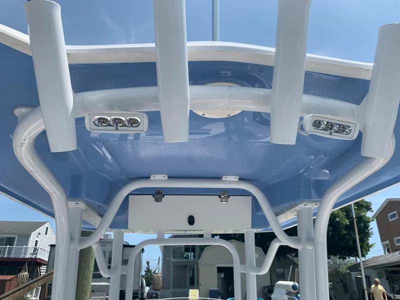 Slide: The Image of 2022 Robalo R230 boat T-top with LED lights and rod holders. - 20