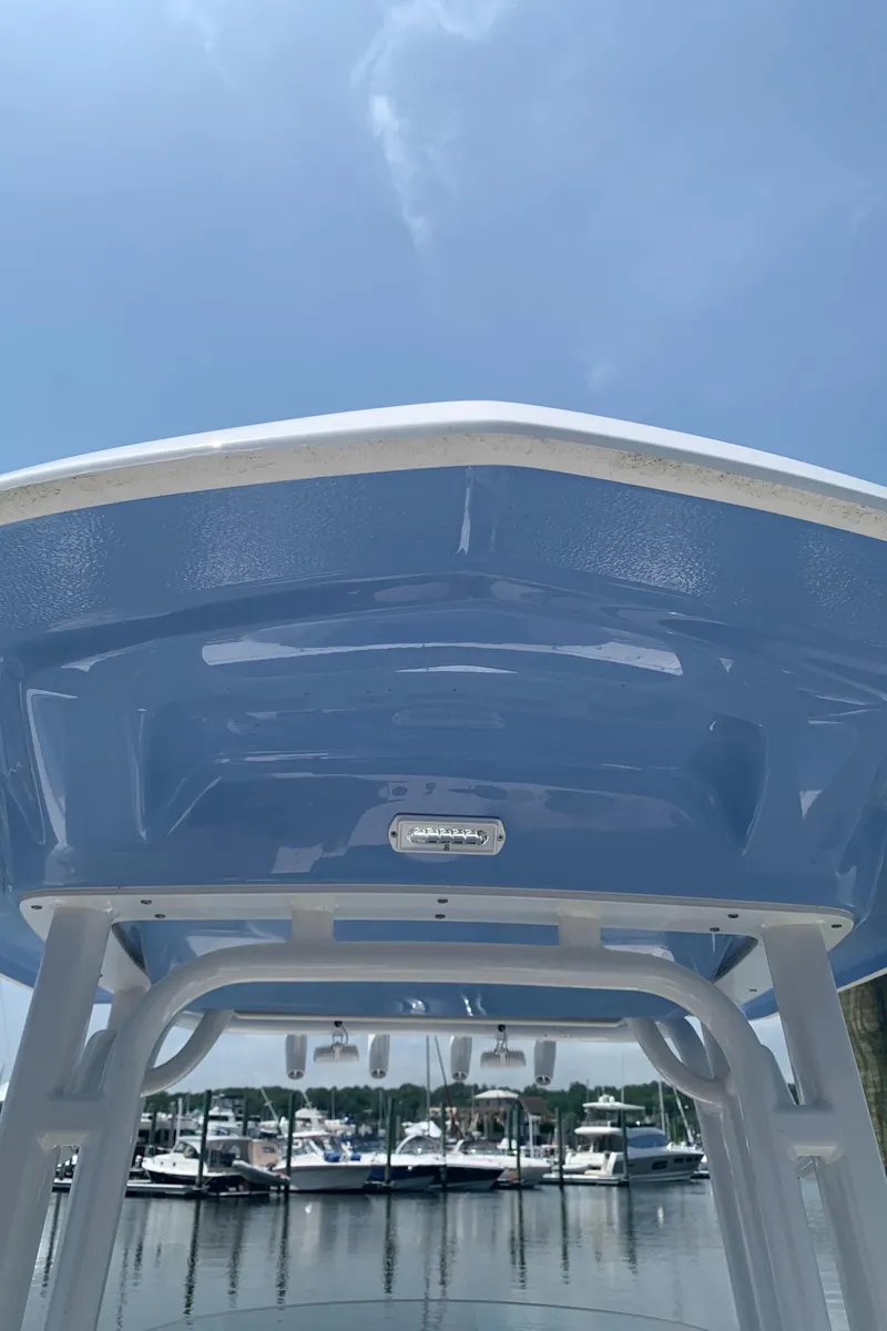 Slide: The Image of 2022 Robalo R230 boat at marina, blue sky background. - 21