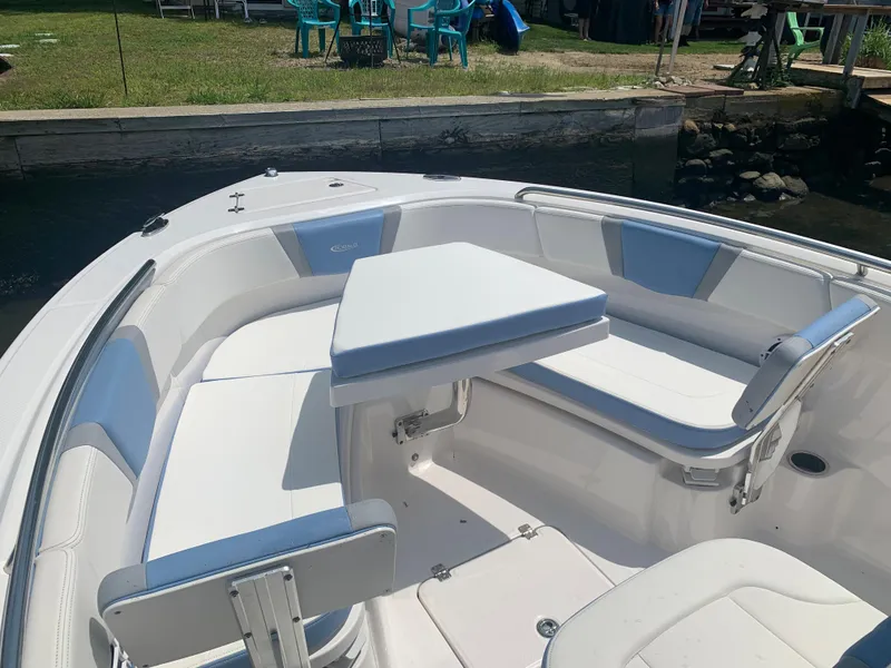 Slide: The Image of 2022 Robalo R230 boat with white seating and table in the bow area. - 24