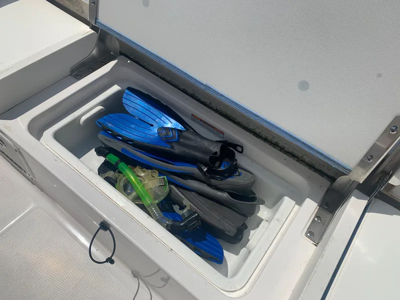 Slide: The Image of 2022 Robalo R230 boat storage compartment with snorkeling gear. - 27
