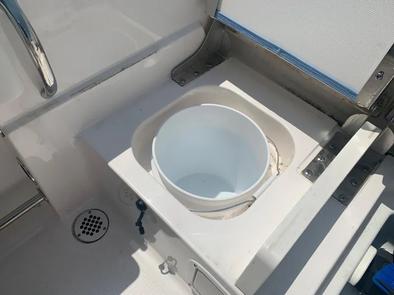 Slide: The Image of 2022 Robalo R230 boat with built-in bucket holder in the deck. - 28
