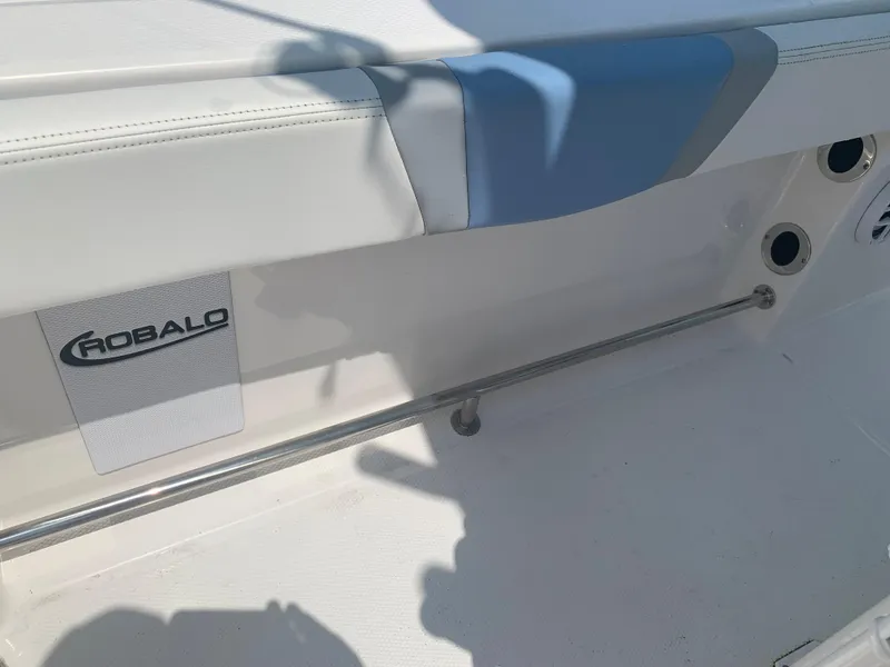 Slide: The Image of 2022 Robalo R230 boat interior with white and blue seating. - 29