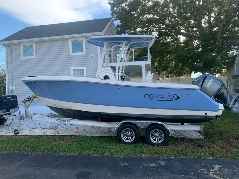 Slide: The Image of 2022 Robalo R230 boat on trailer in front of house. - 37
