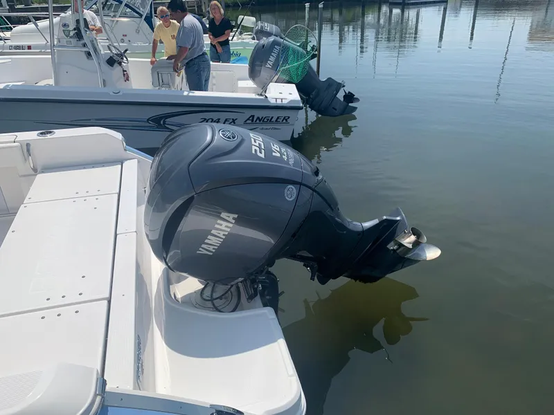 Slide: The Image of 2022 Robalo R230 boat with Yamaha 250 outboard engine docked. - 4