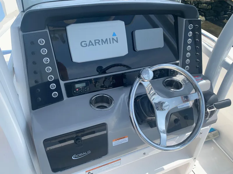 Slide: The Image of 2022 Robalo R230 boat dashboard with Garmin navigation system and steering wheel. - 5