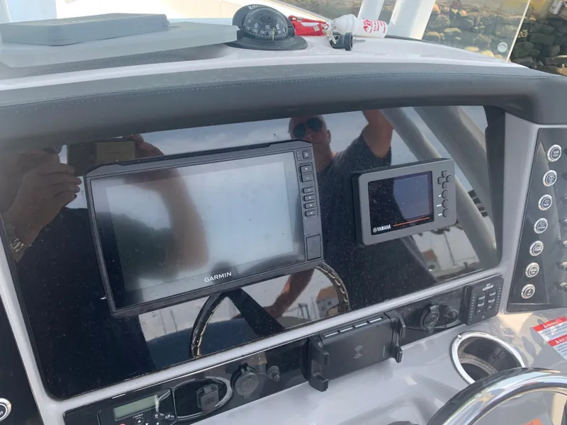 Slide: The Image of 2022 Robalo R230 boat dashboard with Garmin navigation systems. - 6