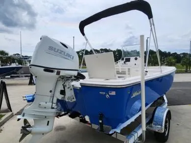 Slide: The Image of 2023 Sundance DX20 boat with Suzuki outboard motor on trailer. - 1