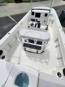 Slide: The Image of 2023 Sundance DX20 boat interior with console, seating, and rod holders. - 10