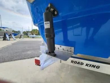 Slide: The Image of 2023 Sundance DX20 boat on Road King trailer, close-up of hydraulic trim tab. - 3