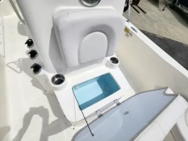 Slide: The Image of 2023 Sundance DX20 boat interior with storage compartment and seating. - 9