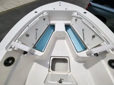 Slide: The Image of 2023 Sea Born LX 24 LE boat with open storage compartments. - 10