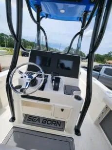 Slide: The Image of 2023 Sea Born LX 24 LE boat console with steering wheel and navigation screens. - 3
