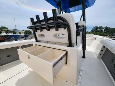 Slide: The Image of 2023 Sea Born LX 24 LE boat with open storage drawer and rod holders. - 4