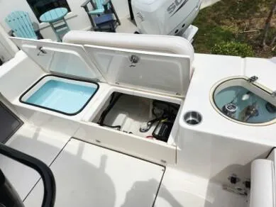 Slide: The Image of 2023 Sea Born LX 24 LE boat with open storage compartments and livewell. - 9