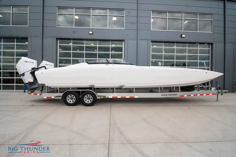 The Image of 2023 Fountain 34 Thunder Cat boat on a trailer outside a modern building. - 1