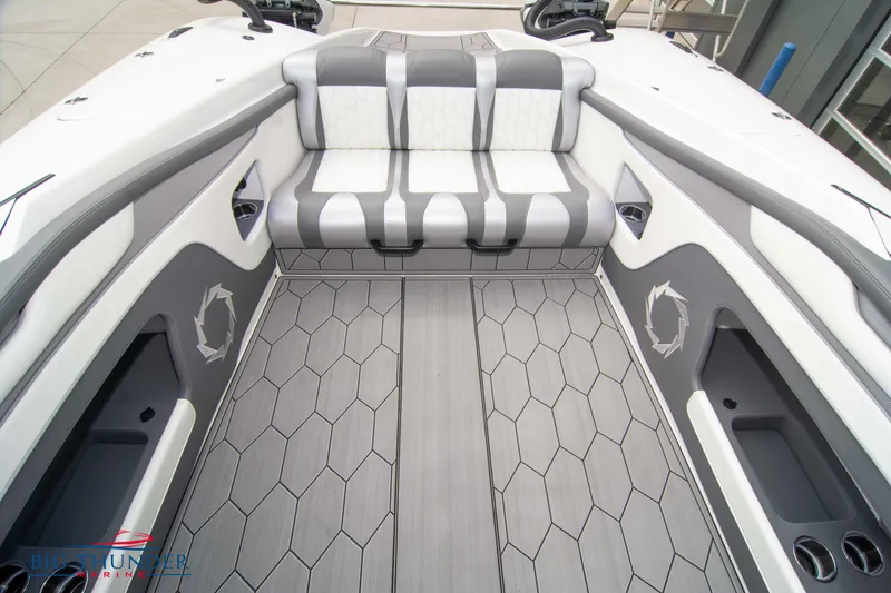 Slide: The Image of 2023 Fountain 34 Thunder Cat boat interior with gray and white seating and hexagonal patterned flooring. - 16