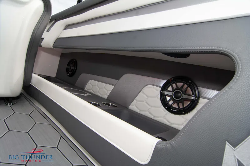 Slide: The Image of 2023 Fountain 34 Thunder Cat interior with speakers and cup holders. - 19