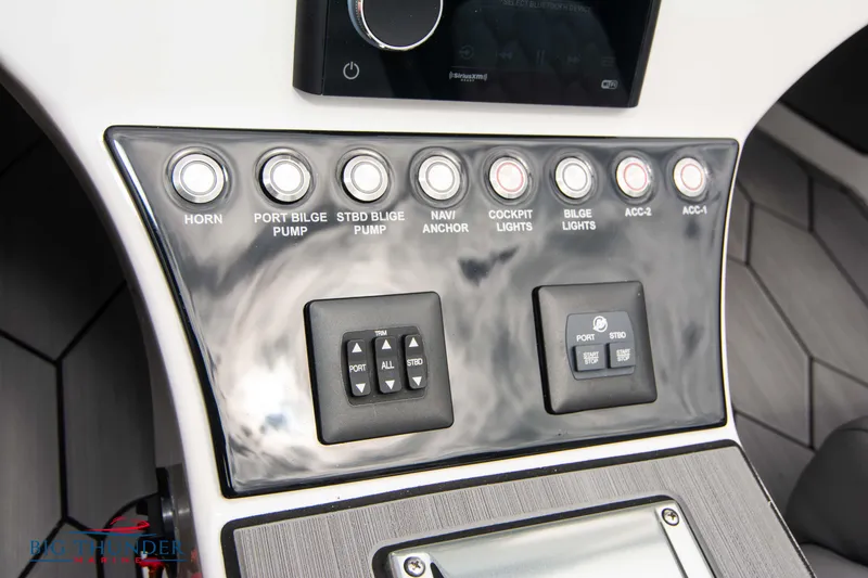 Slide: The Image of Control panel of a 2023 Fountain 34 Thunder Cat boat with various switches and buttons. - 25
