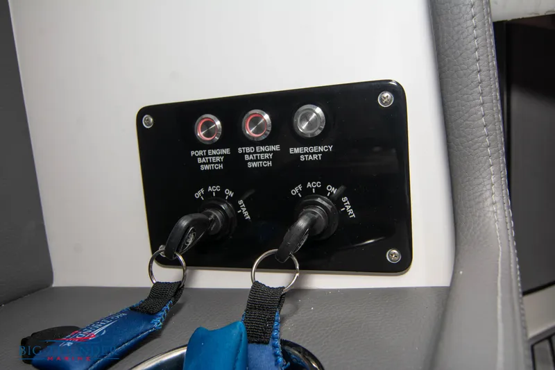 Slide: The Image of Control panel of a 2023 Fountain 34 Thunder Cat boat with engine switches. - 28