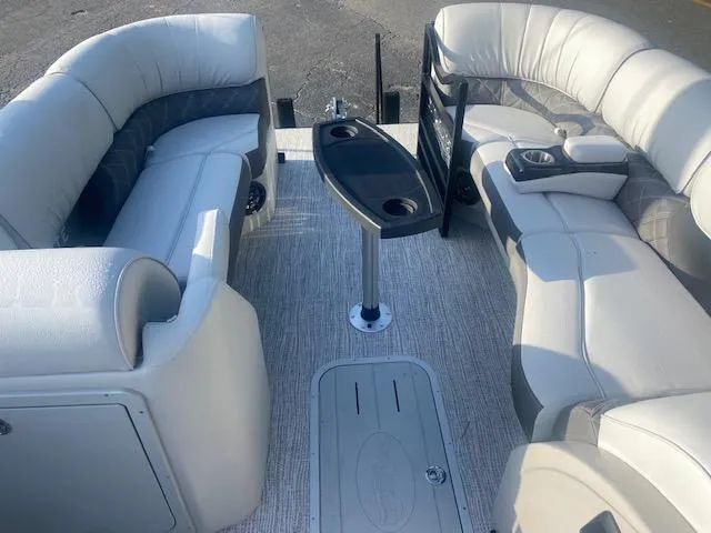 Slide: The Image of 2023 SunCatcher Elite 326 SS boat interior with plush seating and central table. - 10