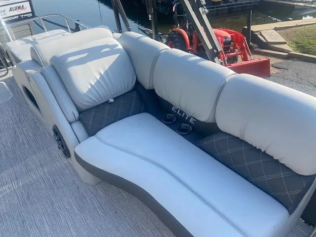 Slide: The Image of 2023 SunCatcher Elite 326 SS boat with luxurious seating and waterfront view. - 11