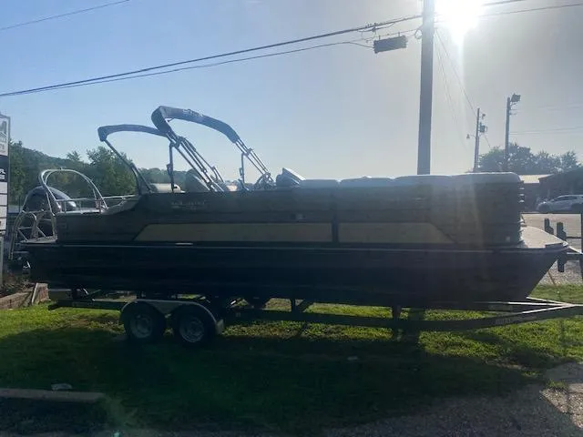 Slide: The Image of 2023 SunCatcher Elite 326 SS pontoon boat on a trailer in a sunny outdoor setting. - 5