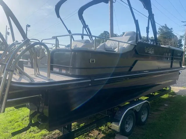 Slide: The Image of 2023 SunCatcher Elite 326 SS pontoon boat on a trailer, rear view. - 6