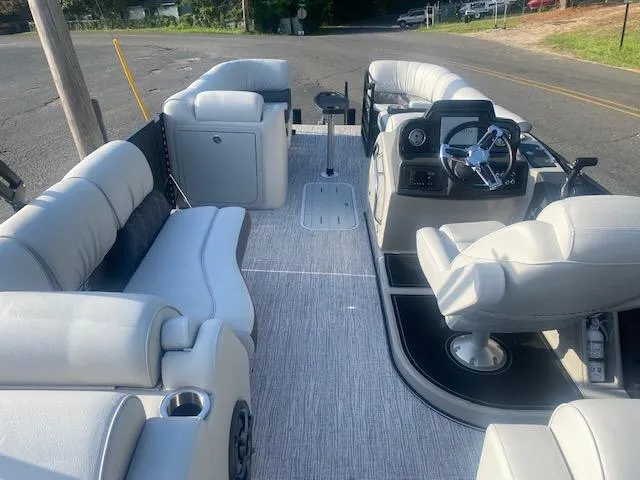 Slide: The Image of 2023 SunCatcher Elite 326 SS pontoon boat interior with plush seating and modern helm. - 8