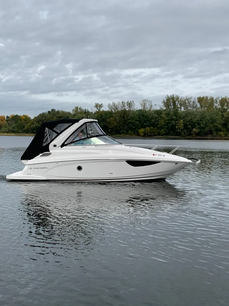 Slide: The Image of 2019 Regal 28 Express boat on a calm lake. - 1