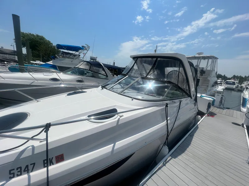 Slide: The Image of 2019 Regal 28 Express boat docked at a marina on a sunny day. - 13