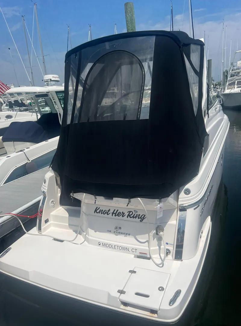 Slide: The Image of 2019 Regal 28 Express boat docked with black canopy. - 15