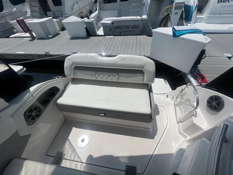 Slide: The Image of 2019 Regal 28 Express boat interior with seating at the dock. - 17
