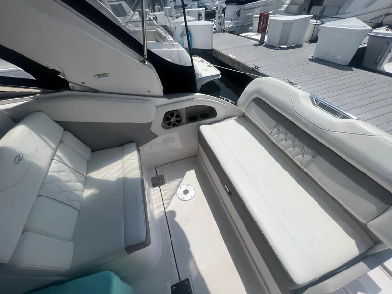 Slide: The Image of Interior seating of a 2019 Regal 28 Express boat at a marina. - 19