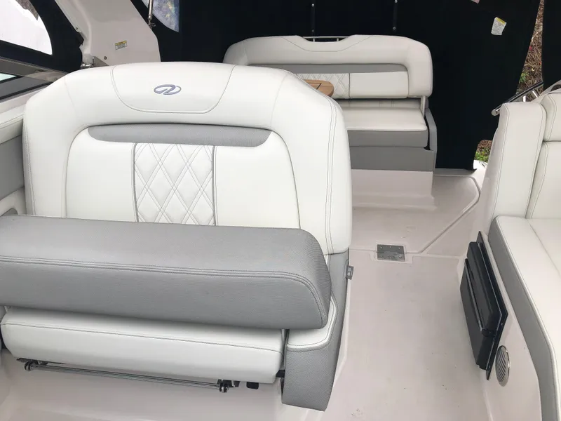 Slide: The Image of 2019 Regal 28 Express boat interior with white and gray seating. - 21