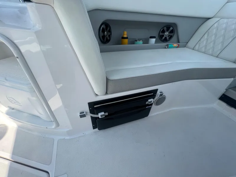 Slide: The Image of Interior seating and storage area of a 2019 Regal 28 Express boat. - 24