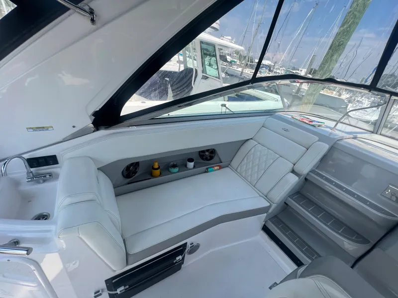 Slide: The Image of Interior seating of a 2019 Regal 28 Express boat with white upholstery. - 25