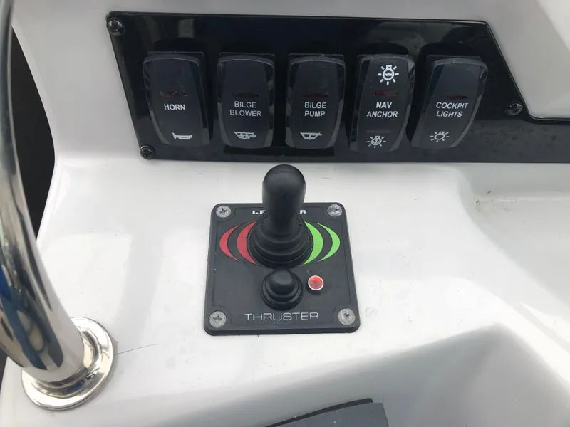 Slide: The Image of Control panel of a 2019 Regal 28 Express boat with joystick and switches. - 28